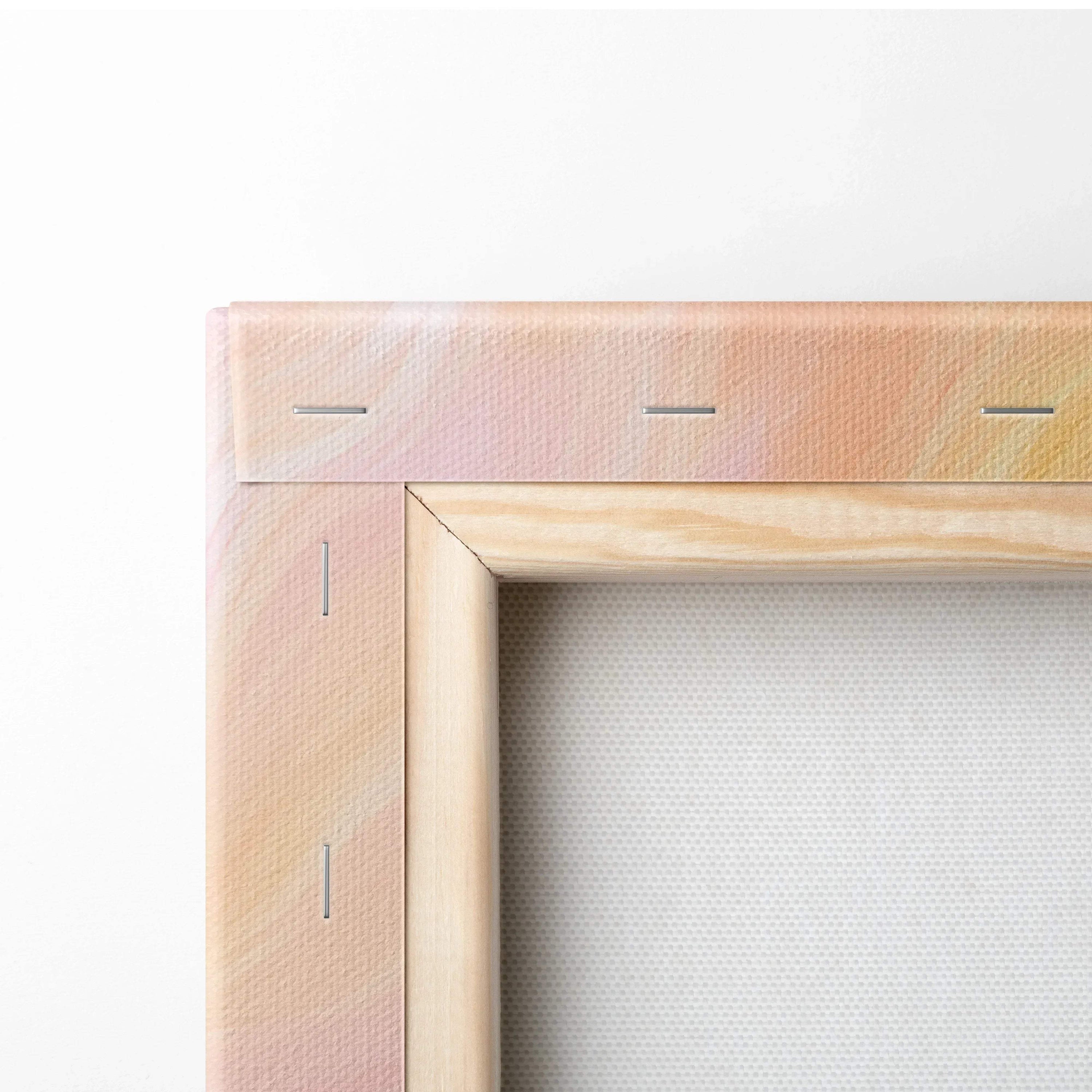 Close-up of natural wood frame with visible staples and neutral-toned canvas backside for wall art.