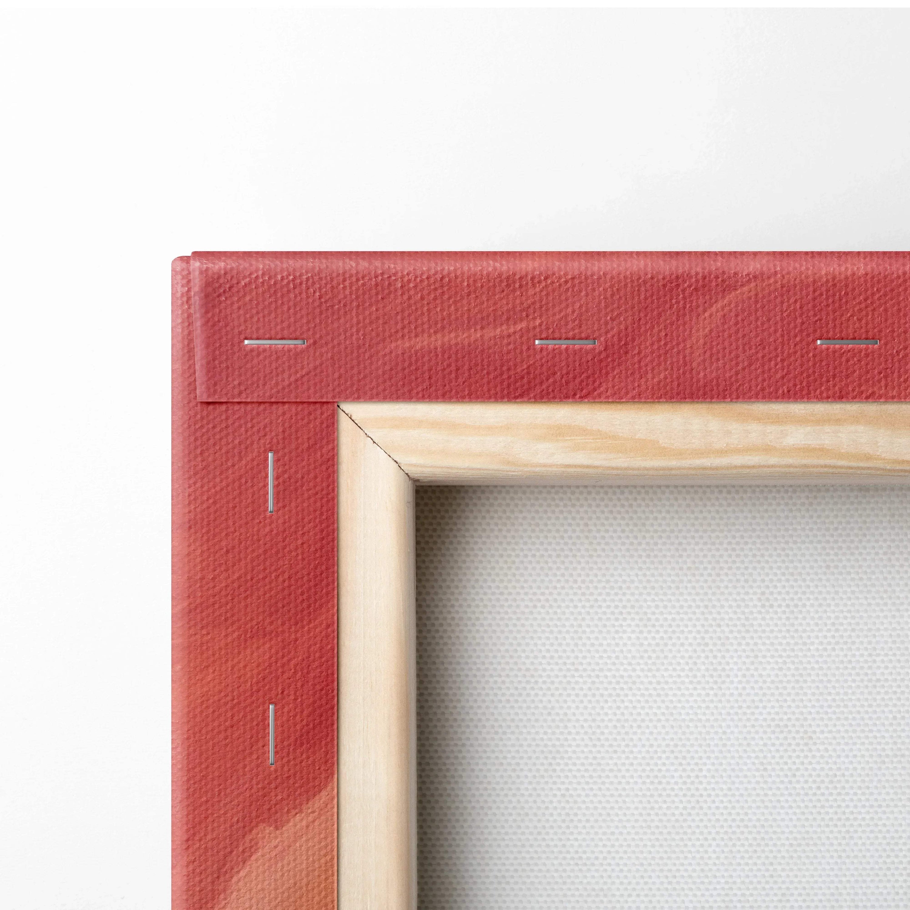 Close-up of wood-framed canvas edge with vibrant red stretch fabric and visible staples on back.