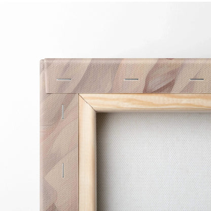 Close-up of natural wood stretcher bars and staple-secured fabric backing on canvas wall art print.