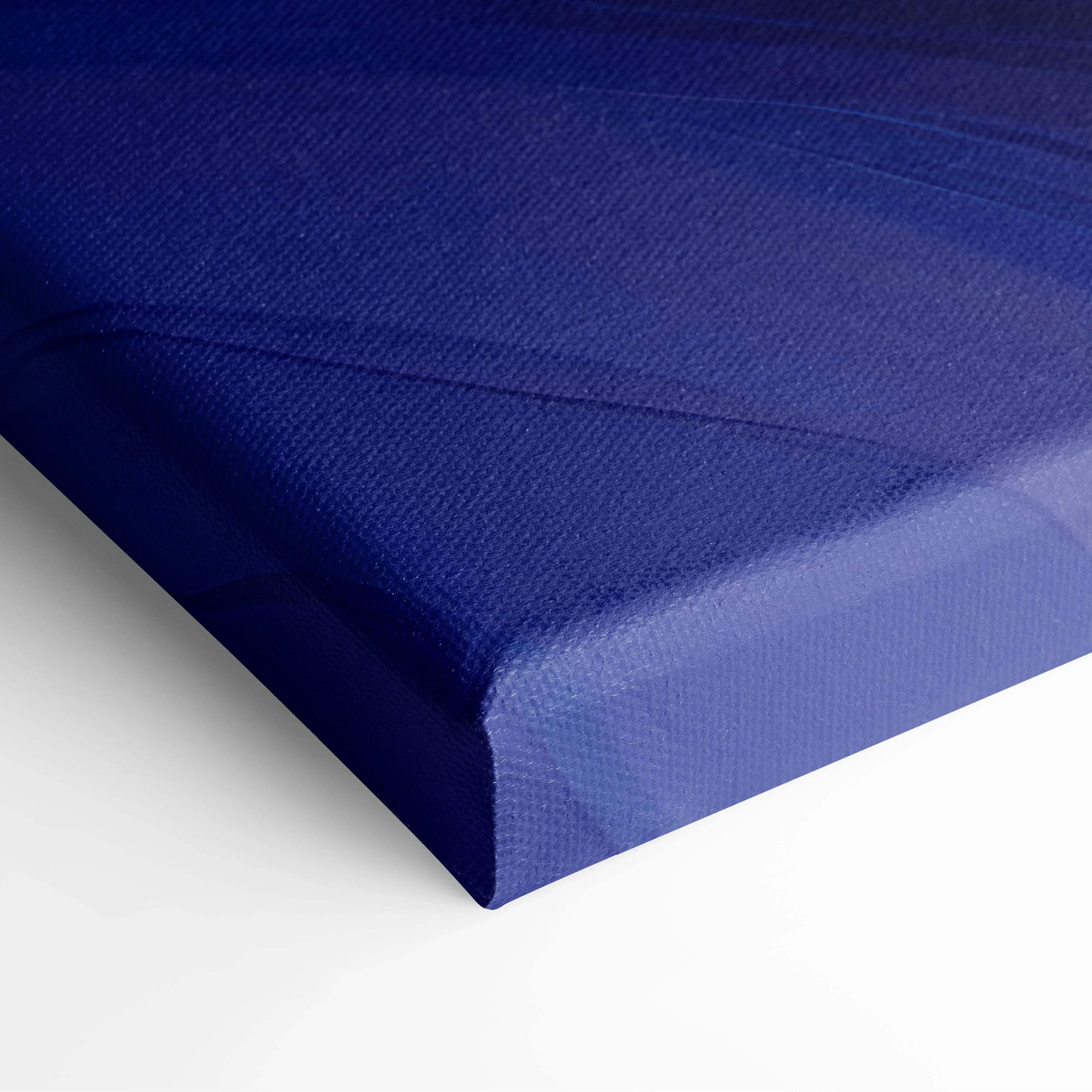 Modern abstract swirl canvas wall art with deep blue textured woven surface and raised edges for living room decor