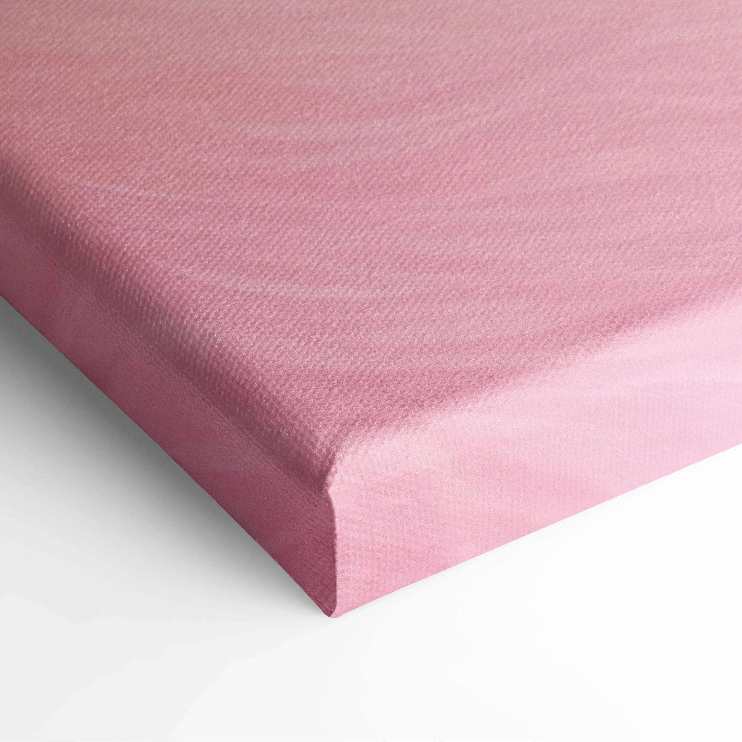 Close-up of pink textured canvas art print stretched tightly over wooden frame for wall decor.