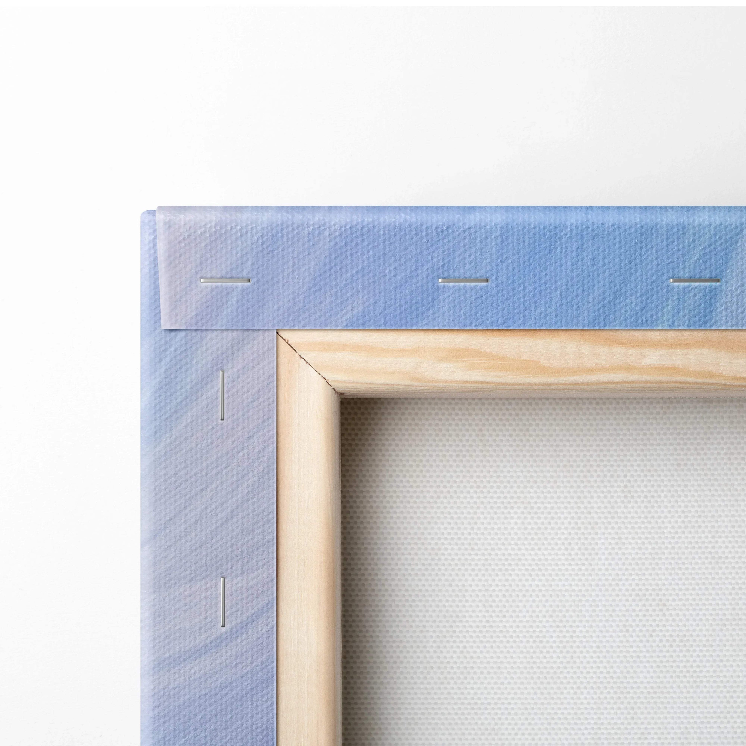 Close-up of wooden stretcher frame with blue-purple abstract print canvas tautly wrapped and stapled on the back.