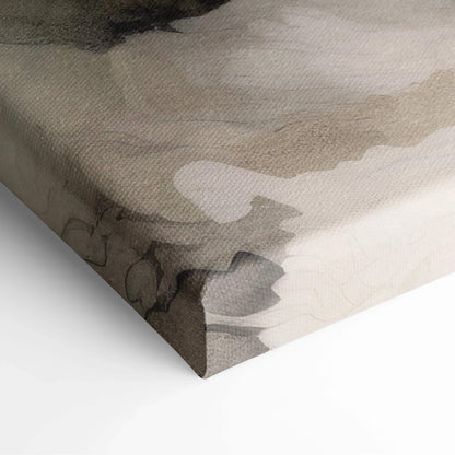 Close-up of abstract canvas wall art with muted beige, gray, and black watercolor-like patterns on textured fabric.