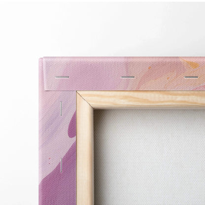 Close-up of a stretched canvas corner with pink and purple abstract paint and wooden frame edges visible.