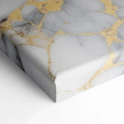 Canvas wall art with abstract design featuring soft gray marble texture and gold veining accents.