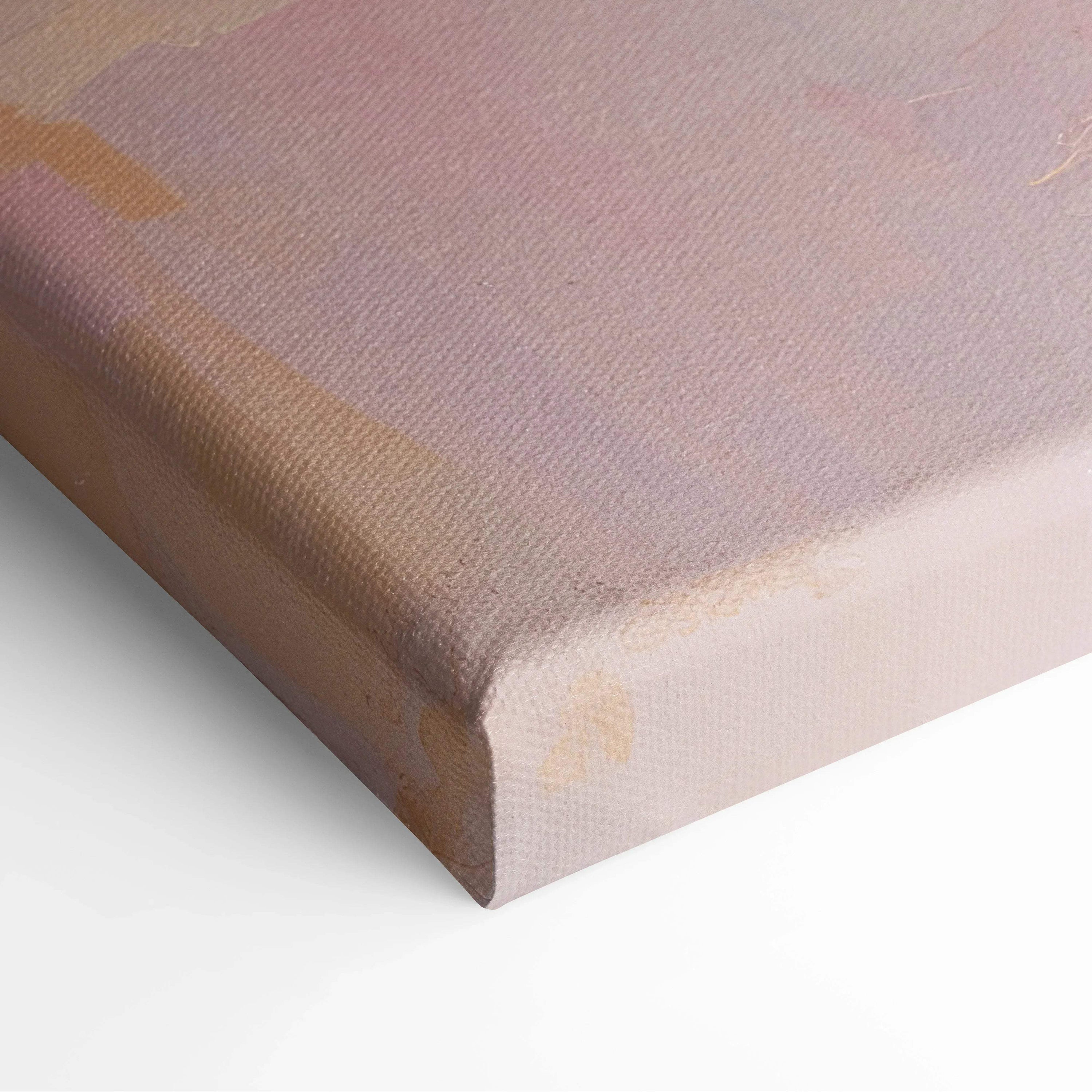 Close-up of a modern abstract canvas art print with soft pastel pinks and subtle beige tones on textured fabric.