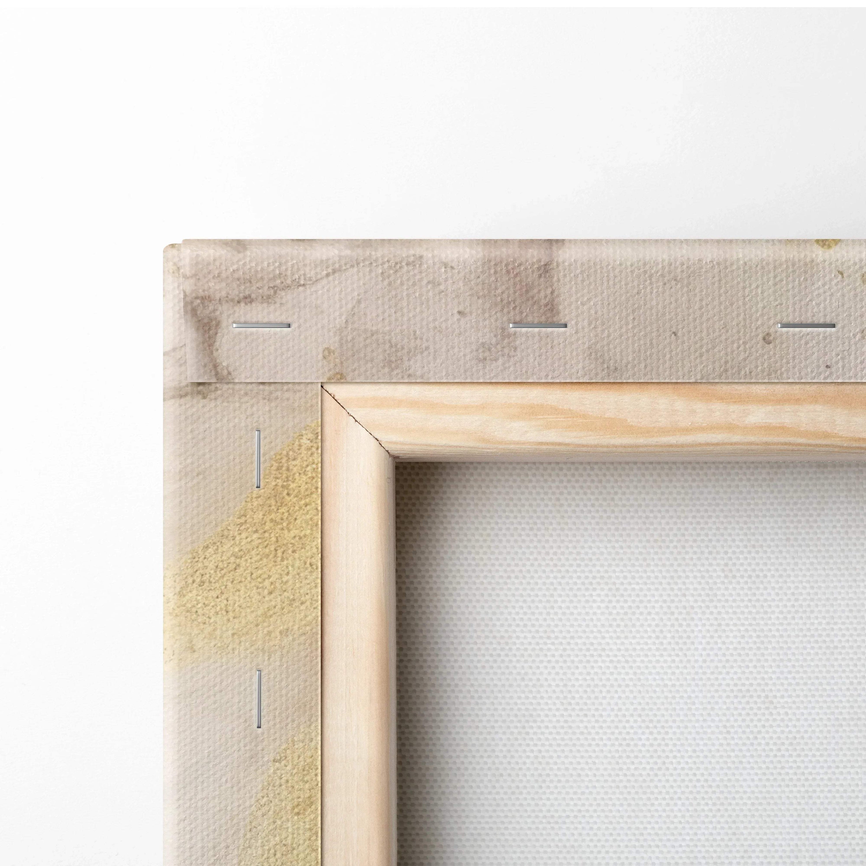 Close-up of canvas stretched over a wooden frame with visible staple fasteners and textured fabric surface.