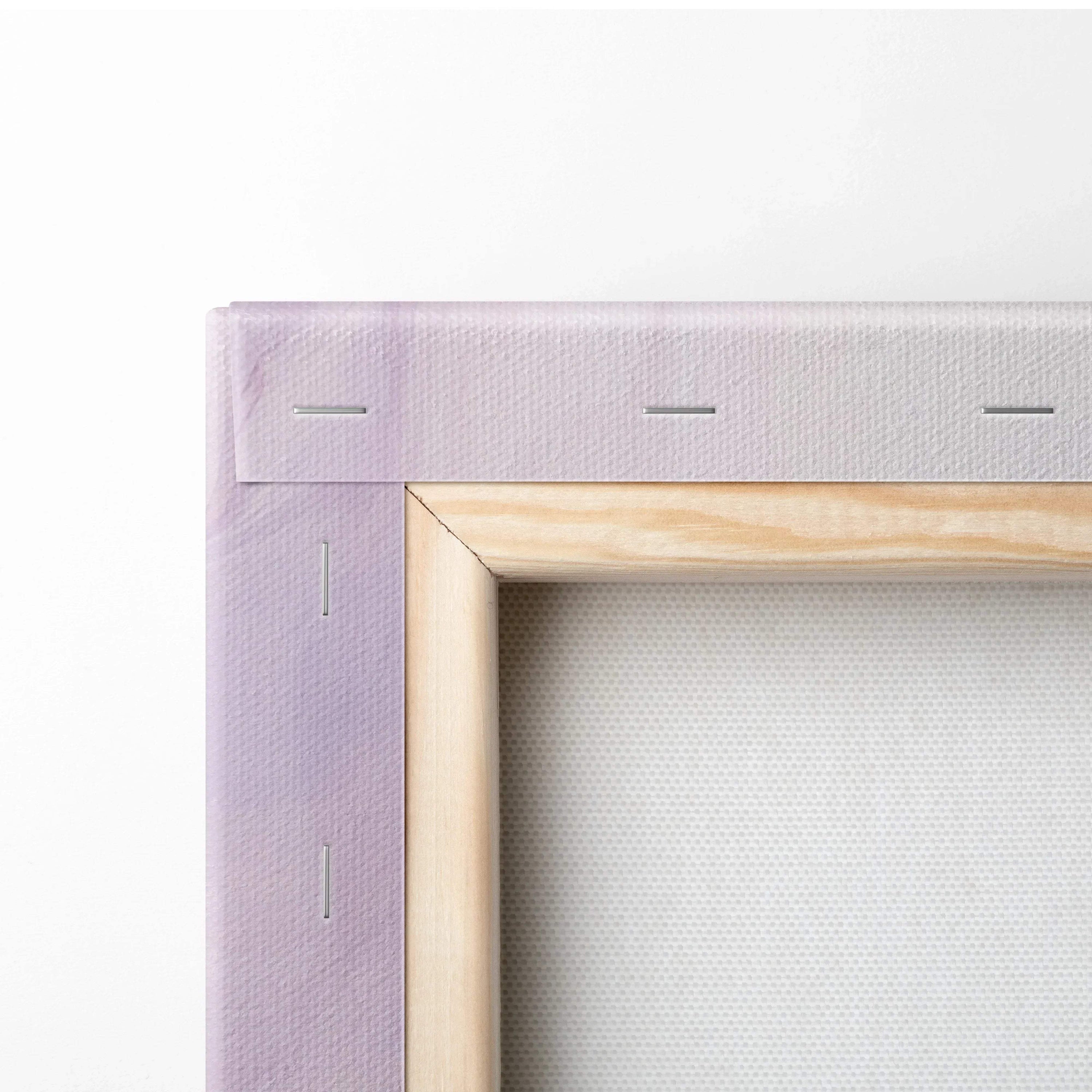 Close-up of canvas corner with purple abstract print stretched over wooden frame, showing staples and texture.