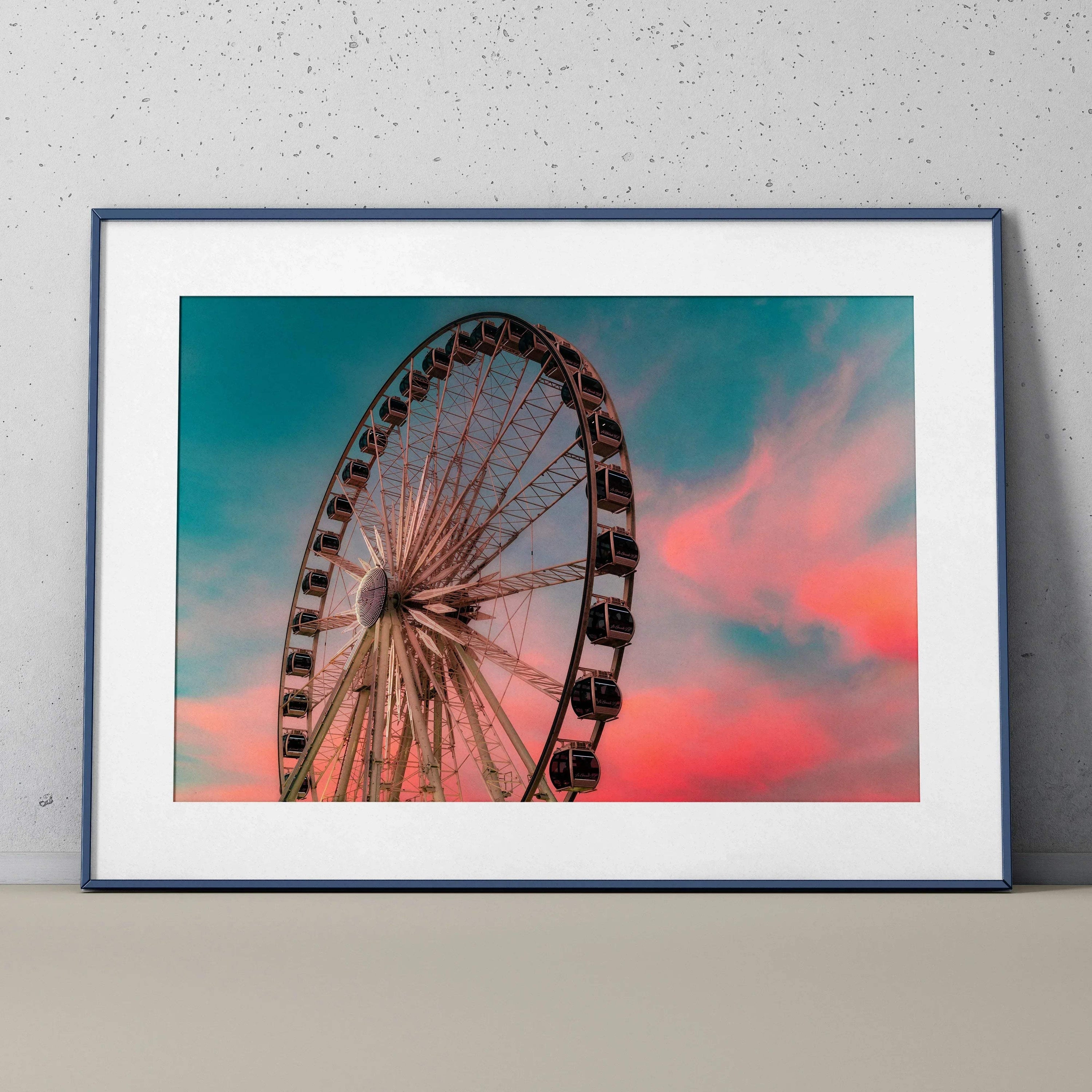 Ferris wheel silhouette against a vibrant pink and blue sunset sky wall art poster.