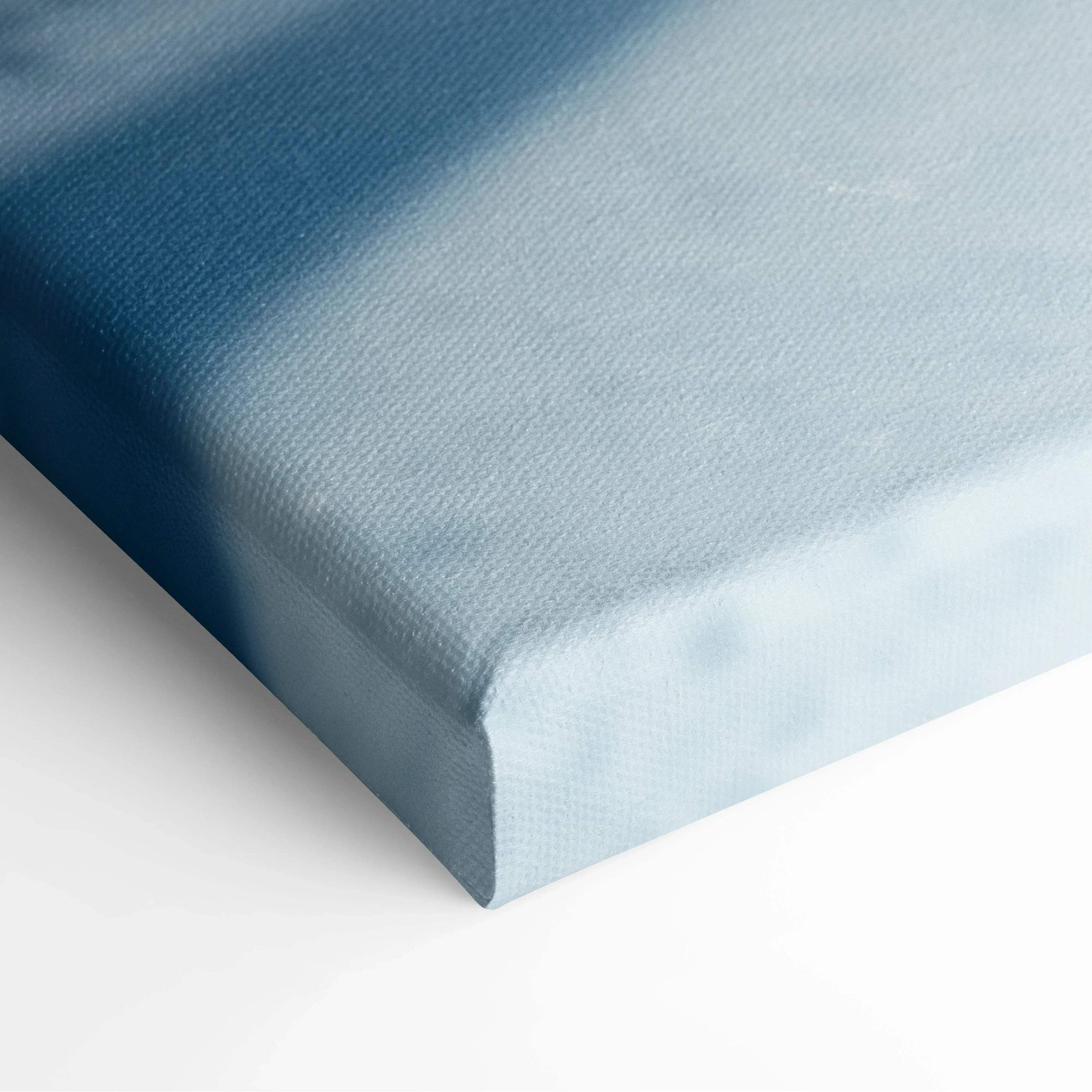 Close-up of serene blue-toned canvas wall art with smooth winter snowscape texture.
