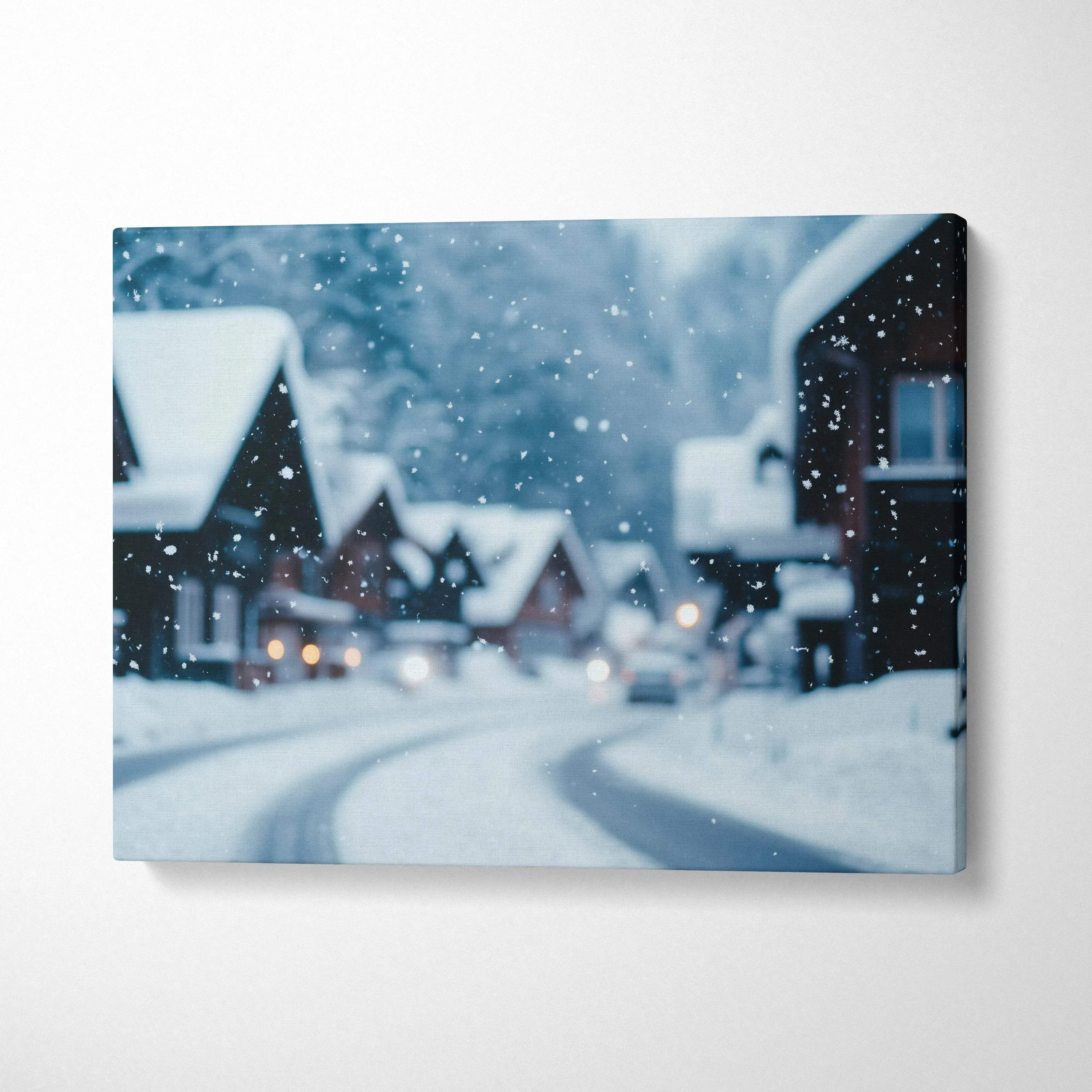 Canvas wall art depicting a snowy village scene with softly falling snow and cozy houses at dusk.