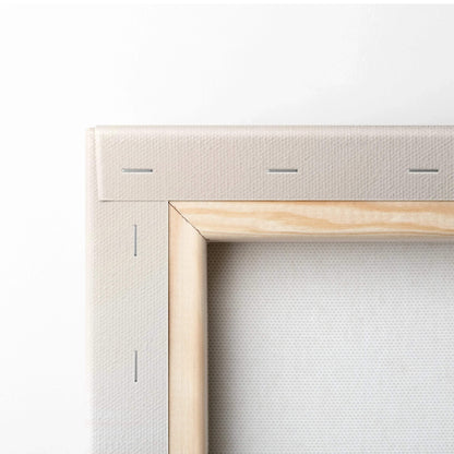 Close-up of blank canvas stretched on wooden frame for wall art display.