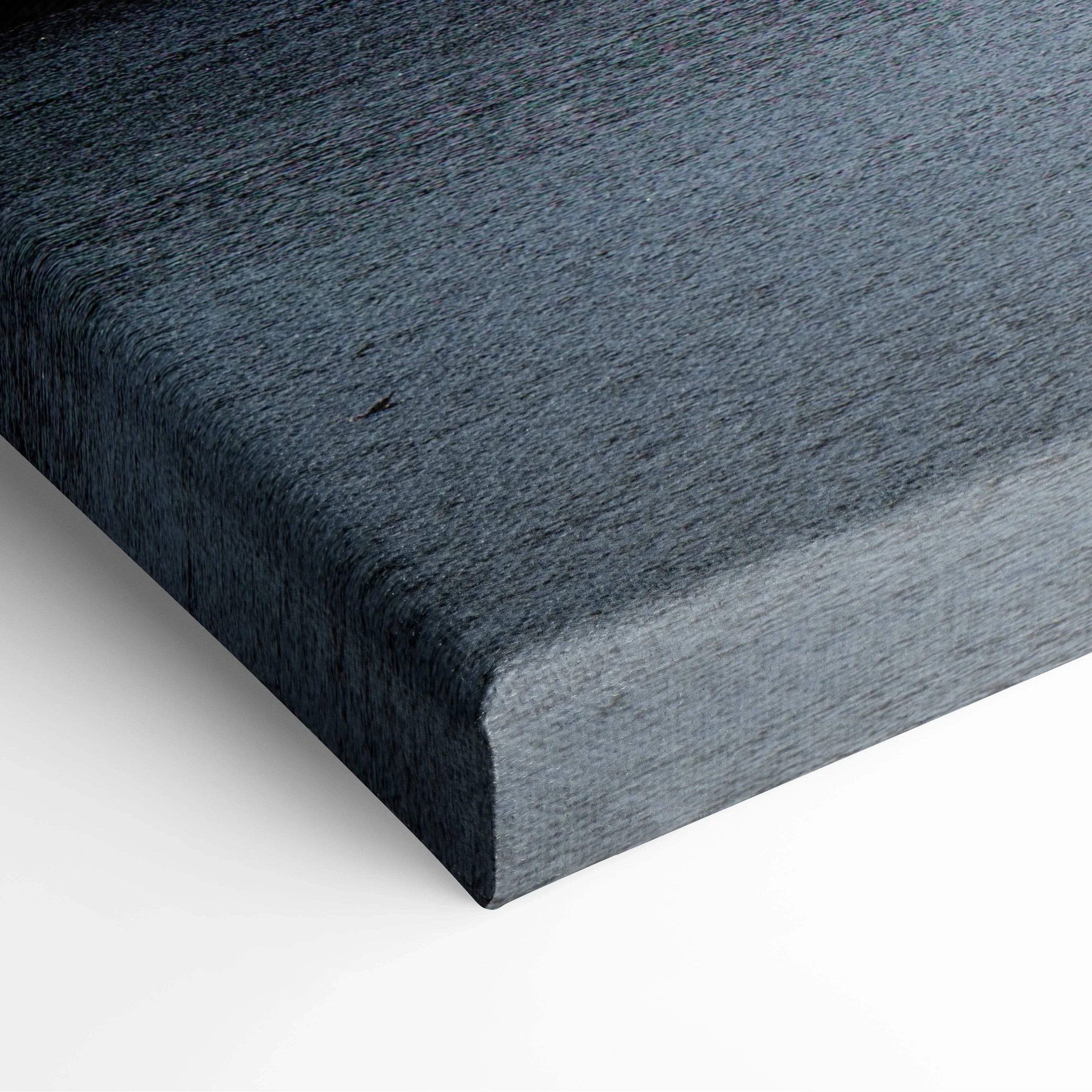 Close-up of textured canvas corner with dark gray and blue tones for wall art.