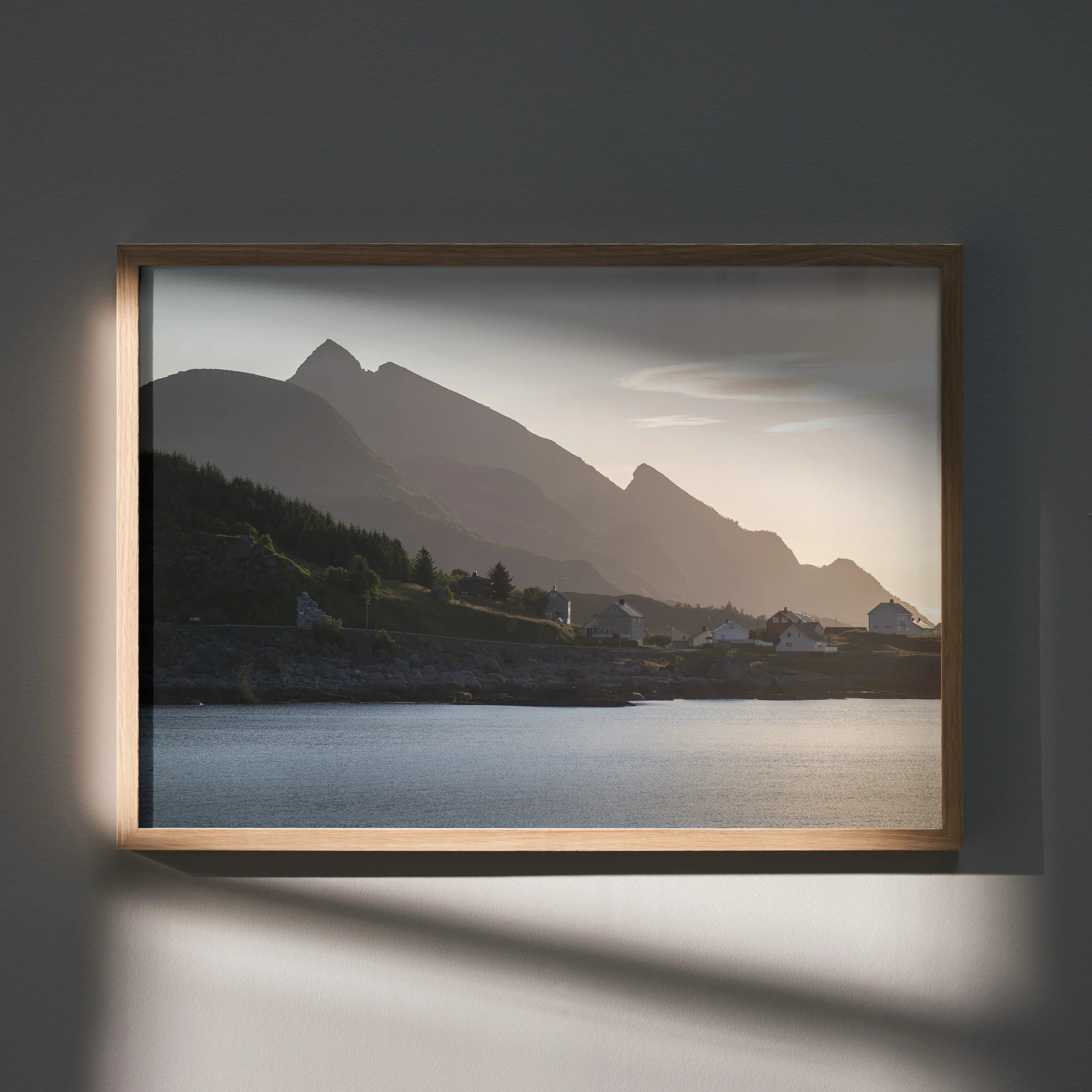 Mountain silhouette with soft sunset sky over calm water, framed wall art poster.