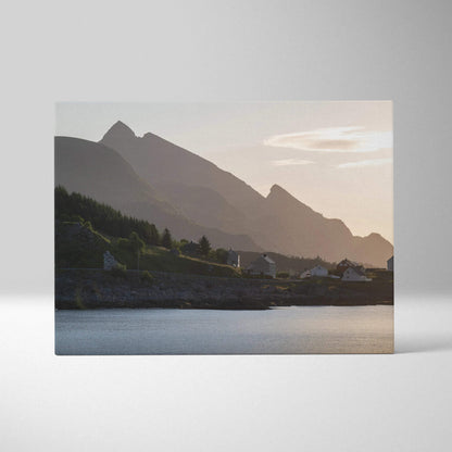 Canvas wall art of mountain silhouettes at sunset with soft pastel sky over calm water.
