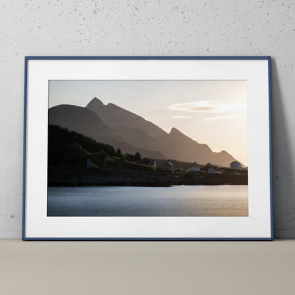 Framed wall art poster depicting mountains at sunset with calm water foreground and soft sky colors.