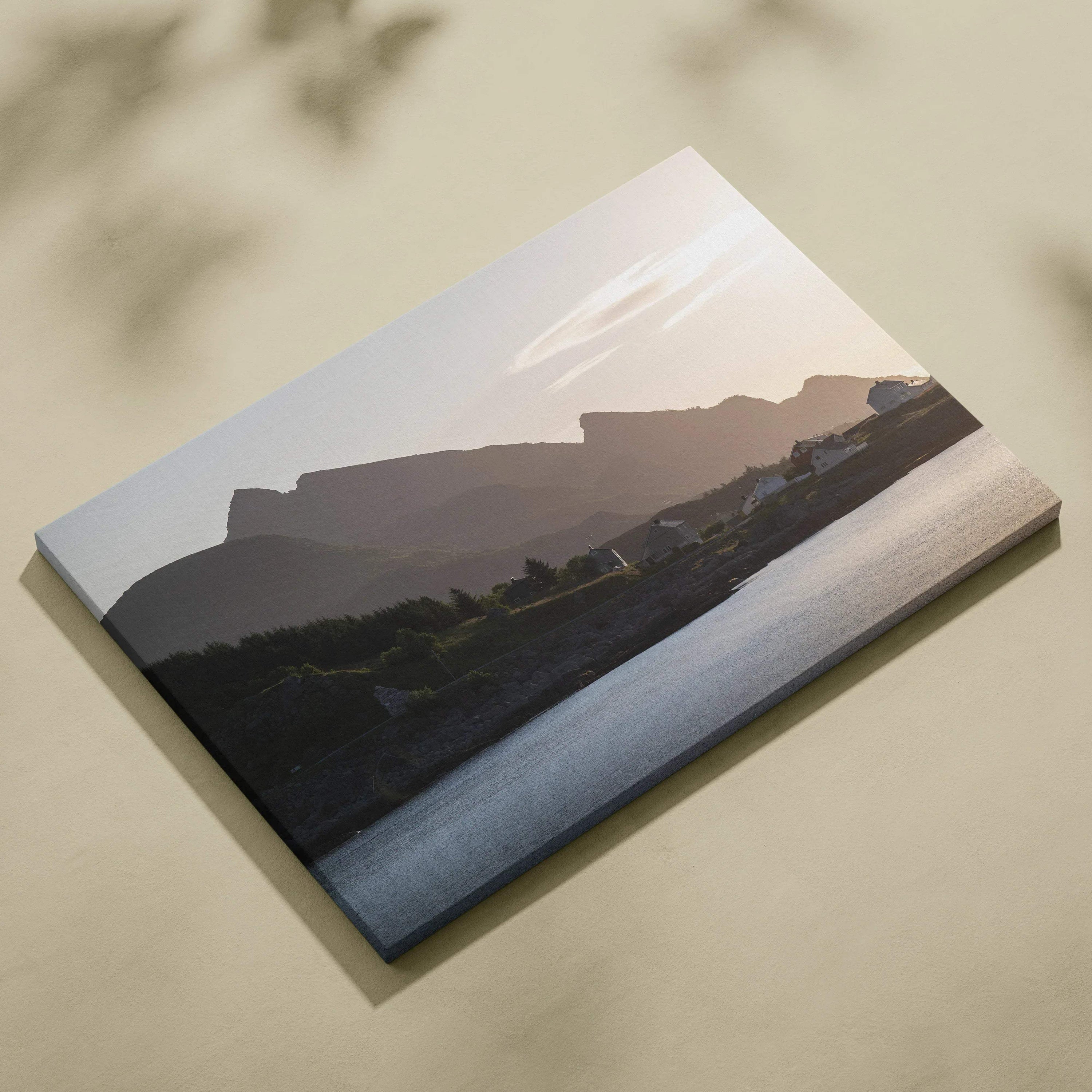 Canvas wall art of a muted mountain sunset over a calm river with soft pastel sky hues.