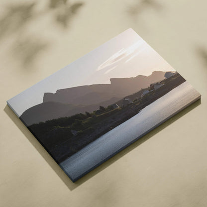 Canvas wall art of a muted mountain sunset over a calm river with soft pastel sky hues.