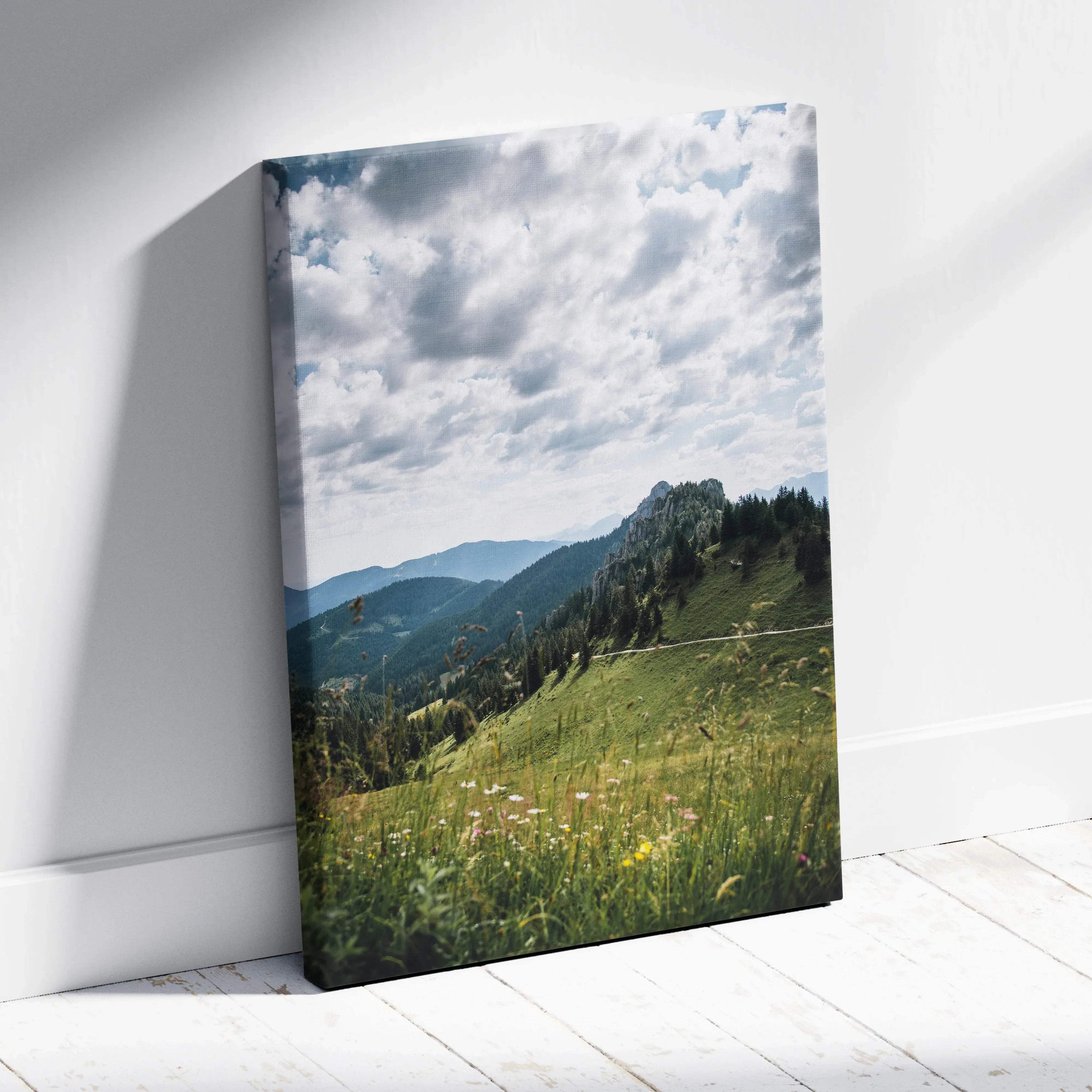 Canvas wall art featuring serene green mountains under a cloudy sky with wildflowers in foreground.