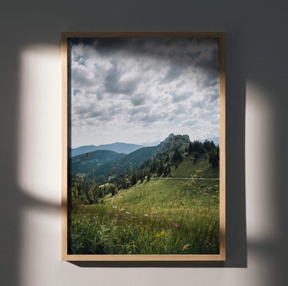 Vertical poster of majestic mountain landscape wall art with cloudy sky and lush green hills.