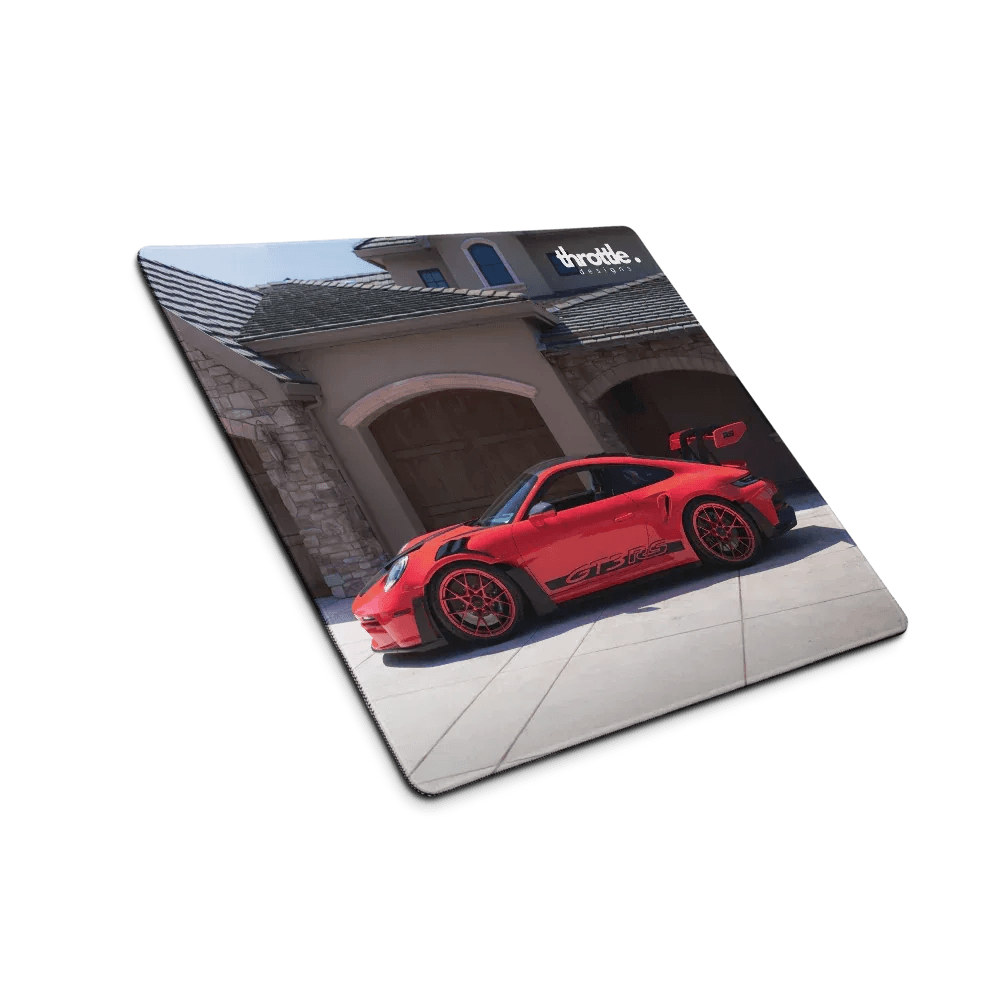 Red porsche 911 gt3 rs sports car with black racing stripes and red alloy wheels on a glossy rectangular gaming mouse pad