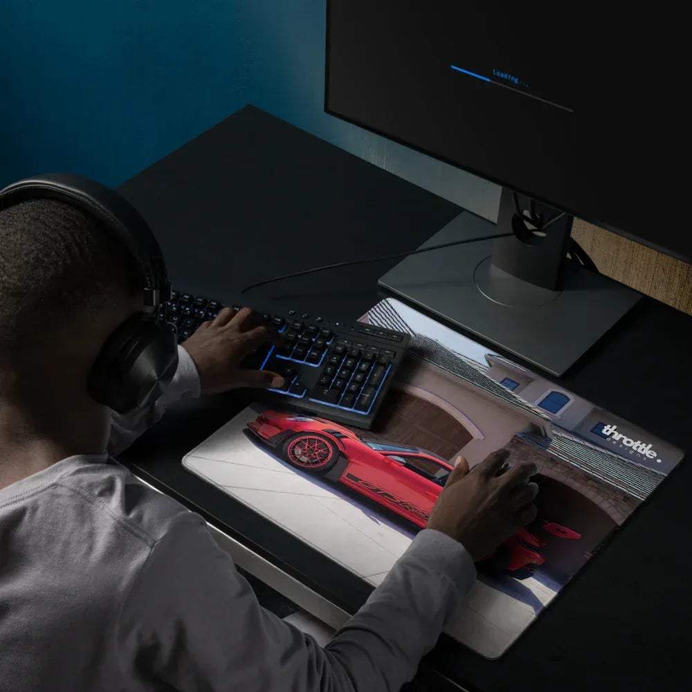 Red sports car graphic on a white and black extended Porsche 911 GT3 RS gaming mouse pad with throttle branding