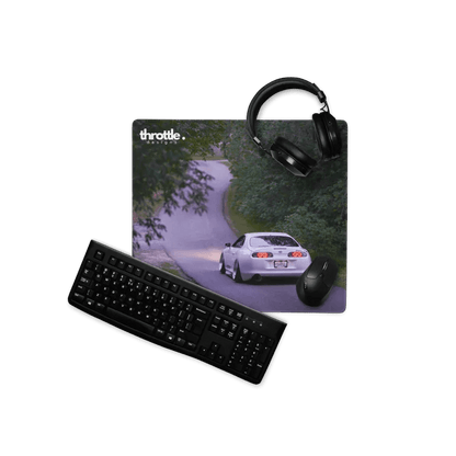 Extended gaming mouse pad featuring a white Toyota Supra Mk4 on a winding forest road, with smooth fabric surface and.