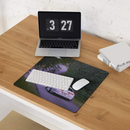 Extended Toyota Supra Mk4 gaming mouse pad with car graphic on wooden desk.