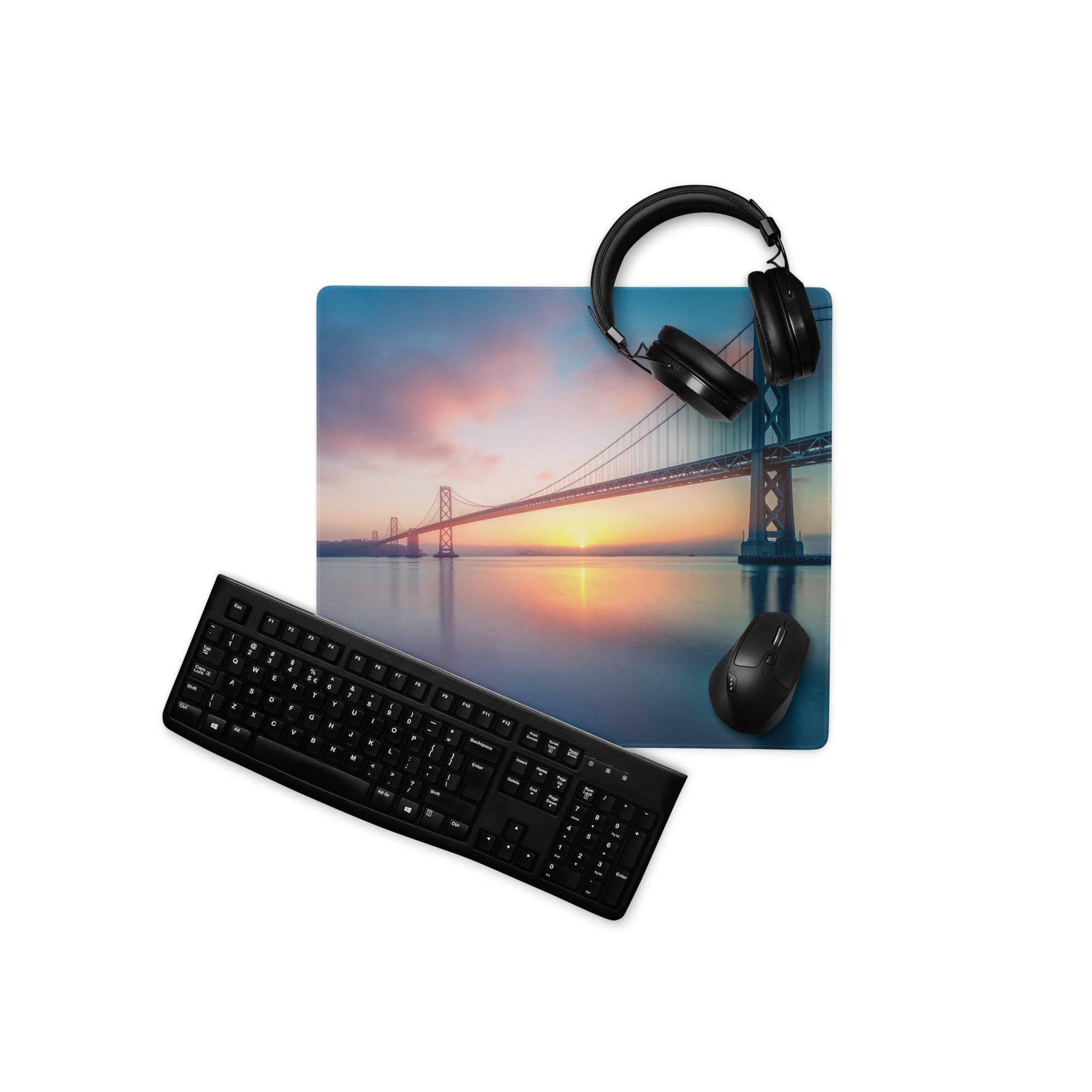 Black keyboard and mouse on Epic Sunset Bridge gaming mousepad