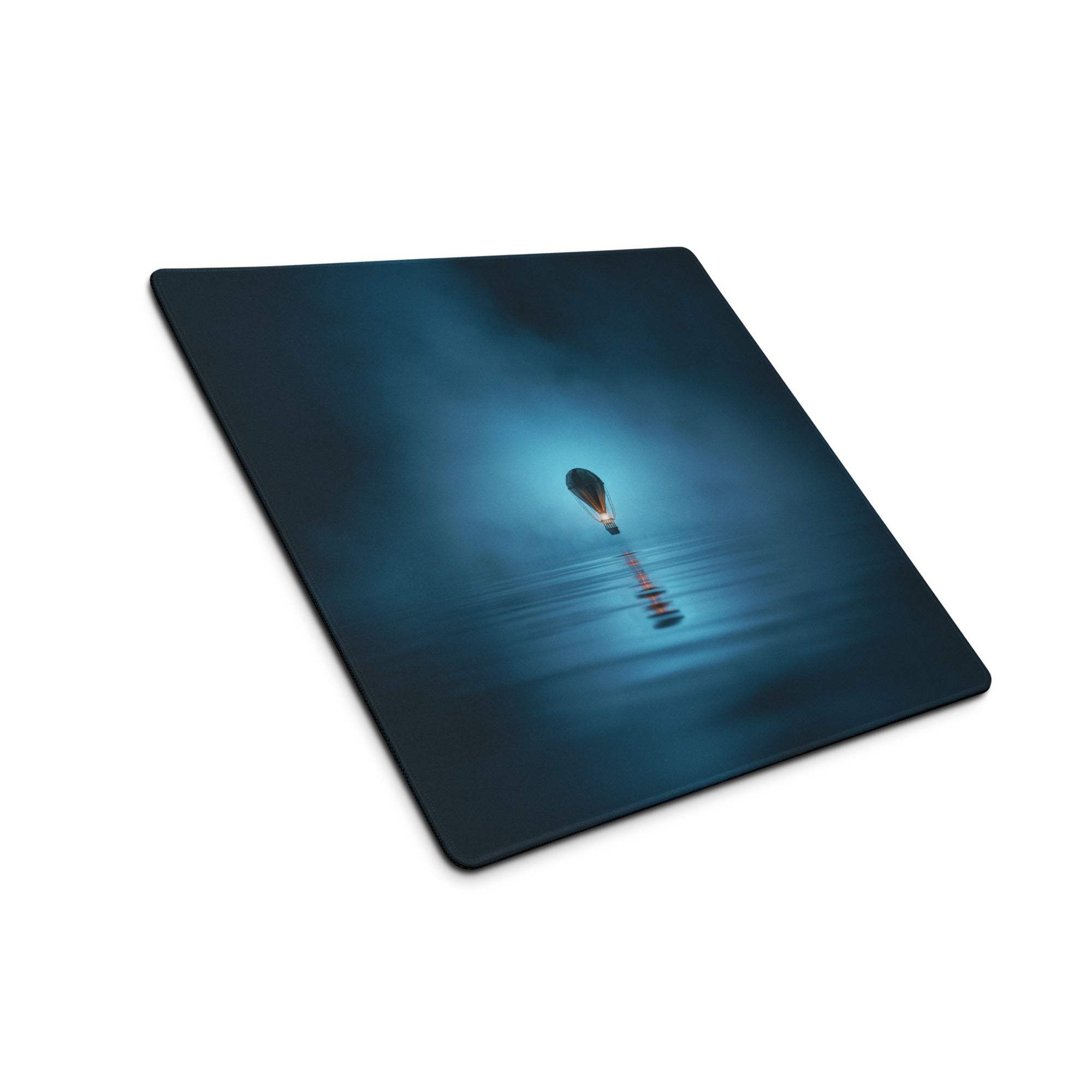 Dark blue gaming mousepad with glowing hot air balloon over calm water reflection