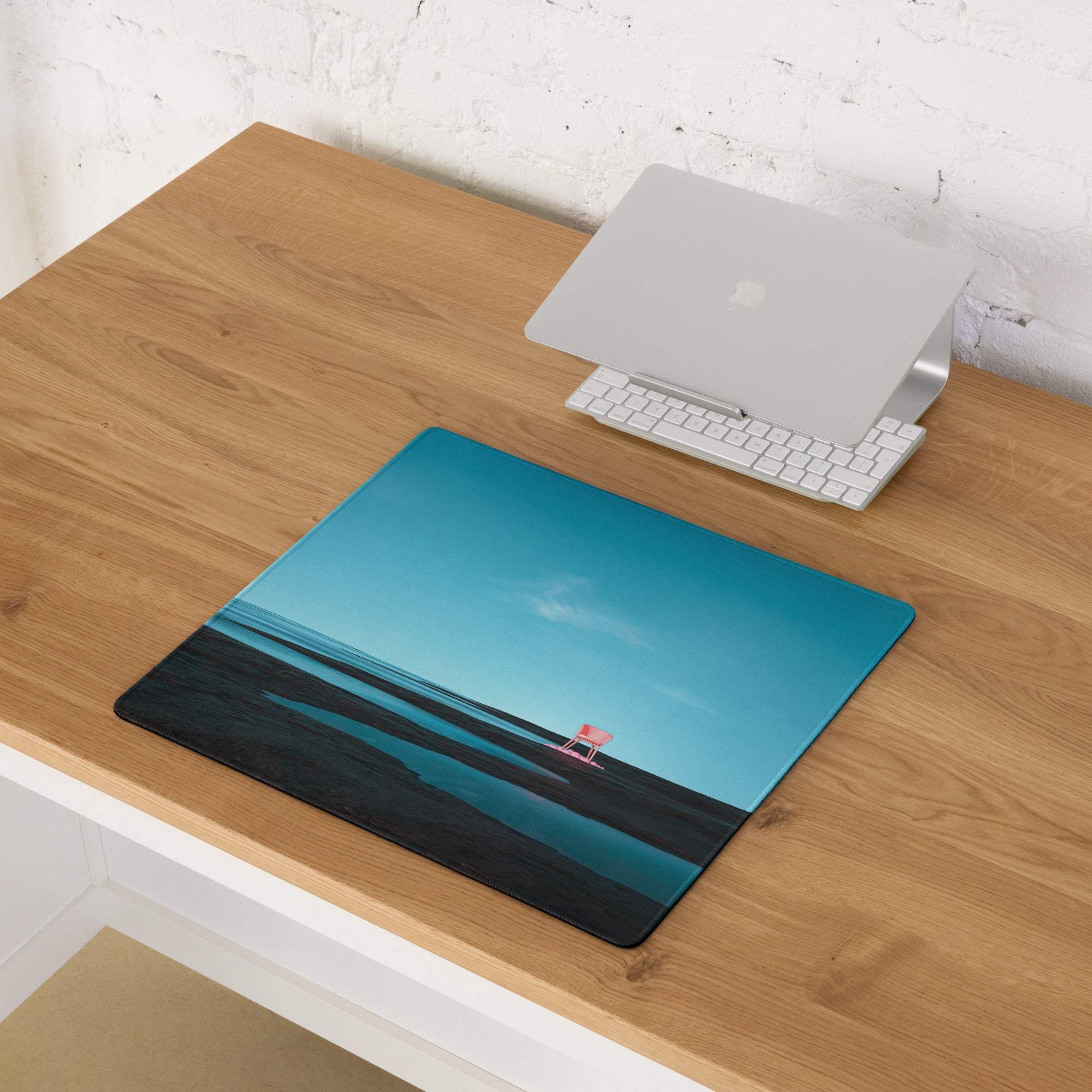 Calm ocean blue beach mousepad with pink chair, black accents, non-slip base