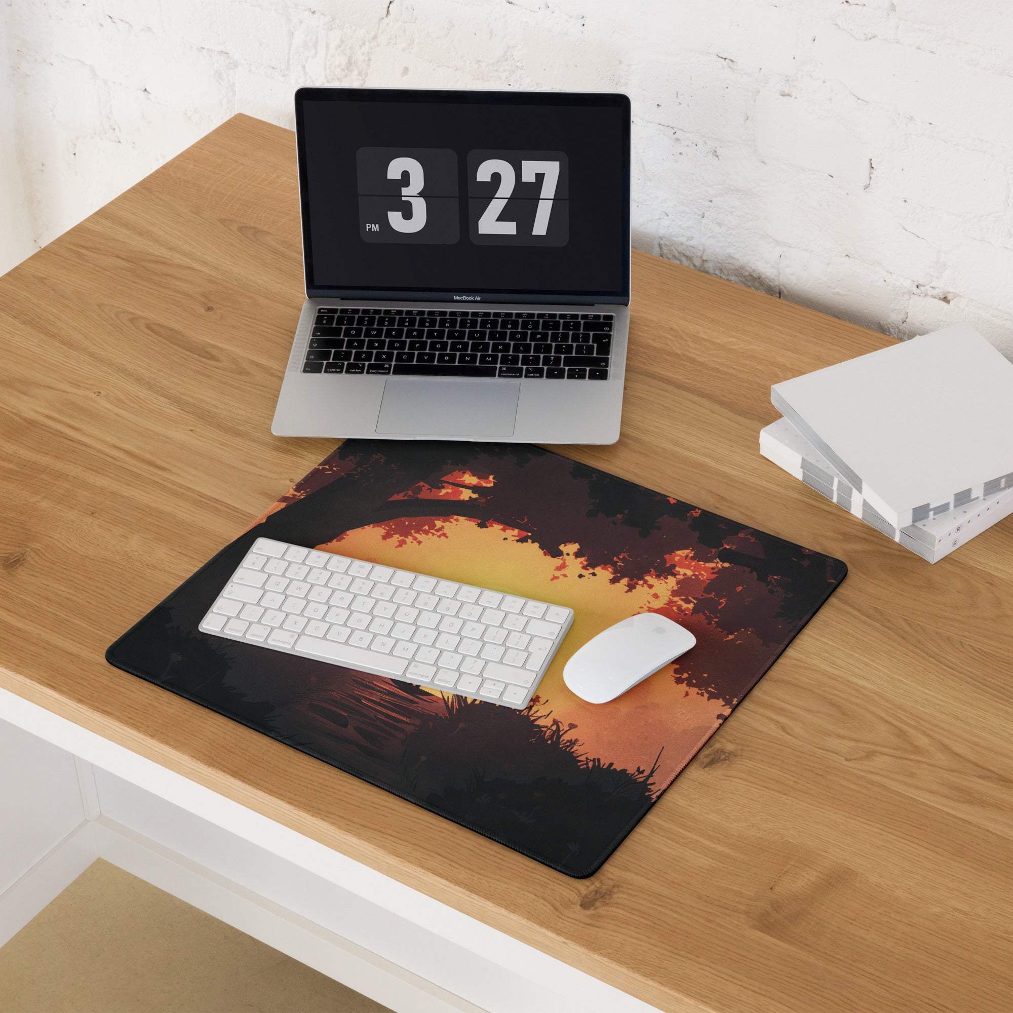 Epic Sunset Forest Silhouette gaming mouse pad in warm orange on wood desk