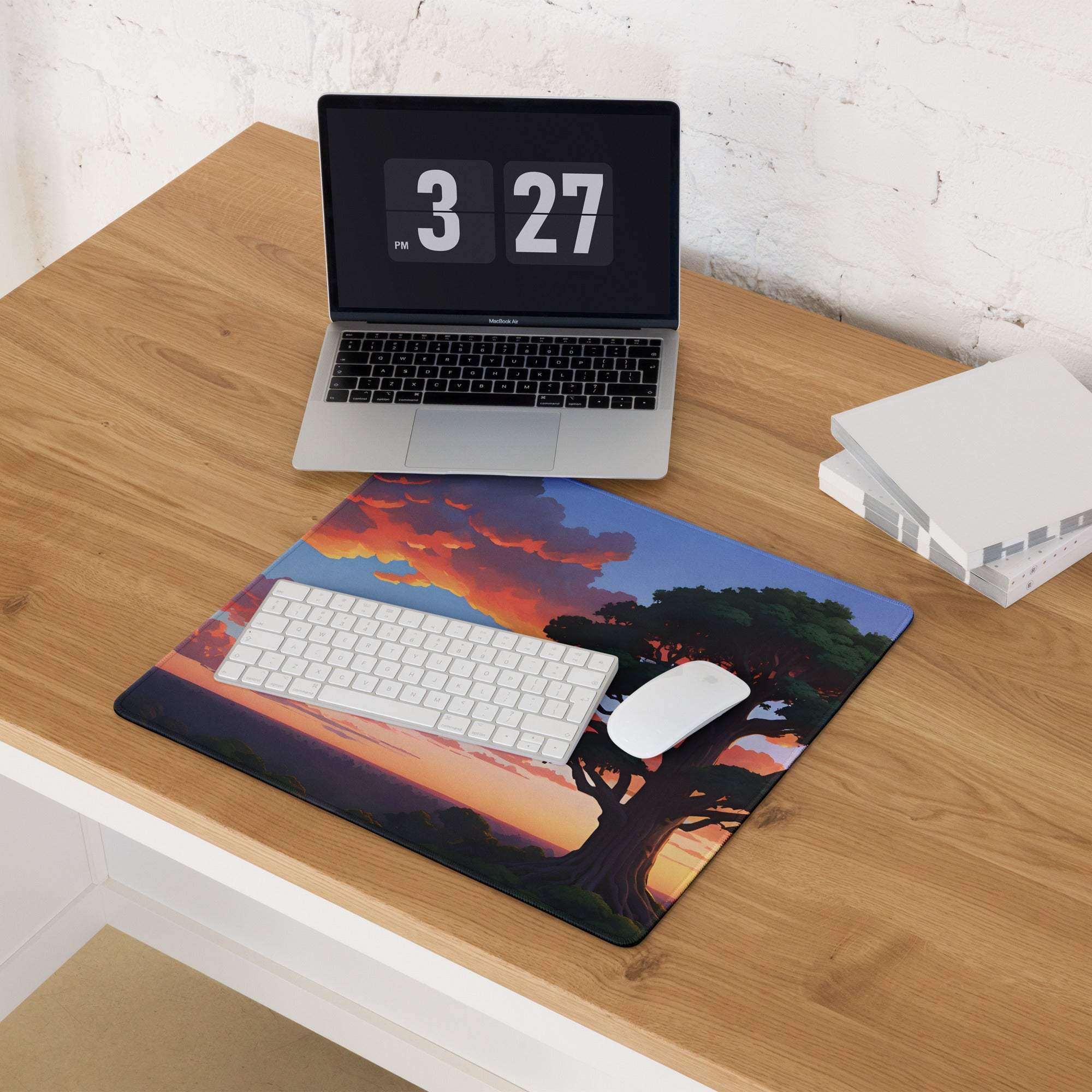 Large stylized vibrant sunset tree landscape gaming mouse pad on wooden desk