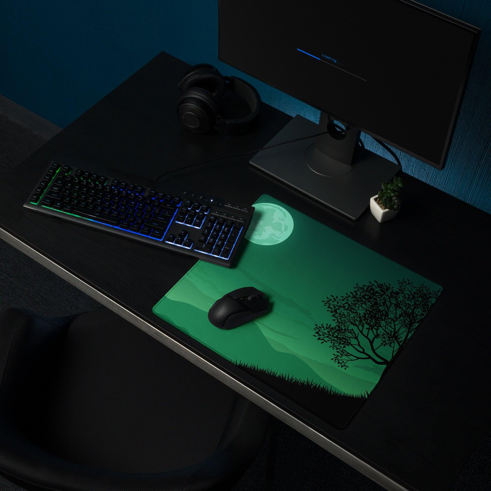 Green moonlit forest mousepad with black tree silhouette and grass