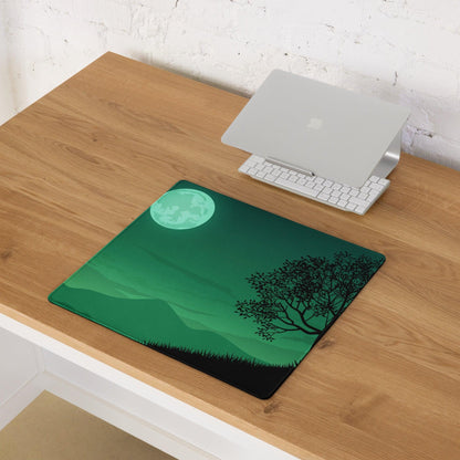 Green landscape gaming mouse pad with glowing teal moon, black tree silhouette