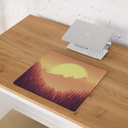 Epic Sunset Mountain Forest gaming mouse pad with vibrant sunset over silhouetted mountains on wooden desk