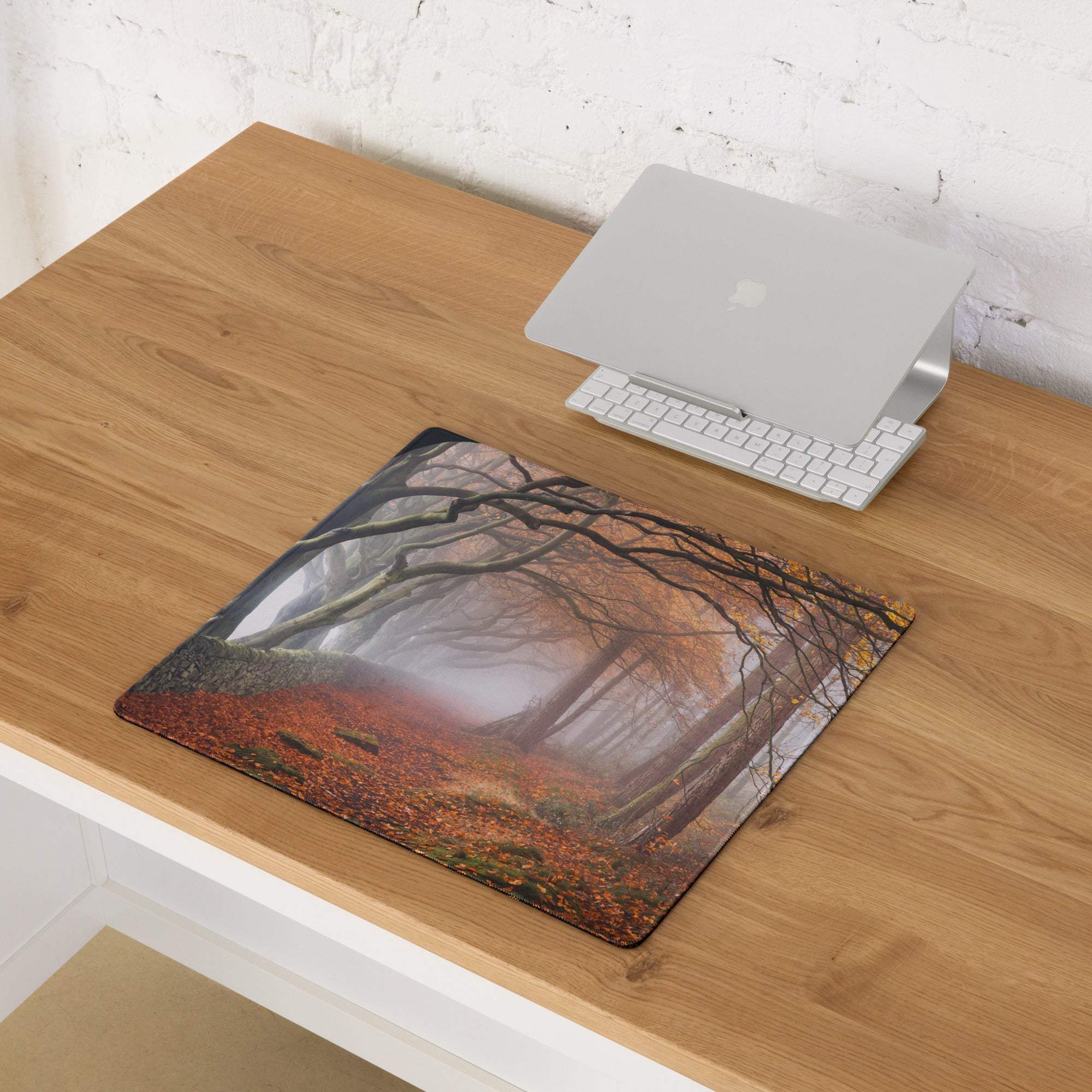 Nature-inspired autumn forest gaming mouse pad with misty path, edge stitching, non-slip backing