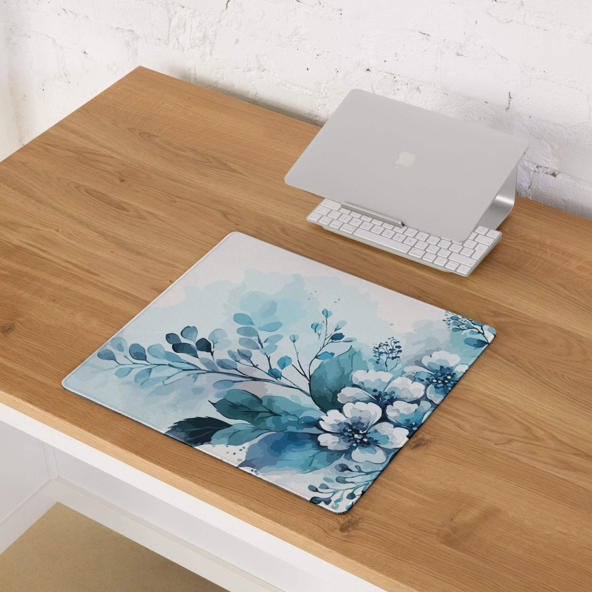 Blue floral watercolor gaming mouse pad with non-slip base and stitched edges