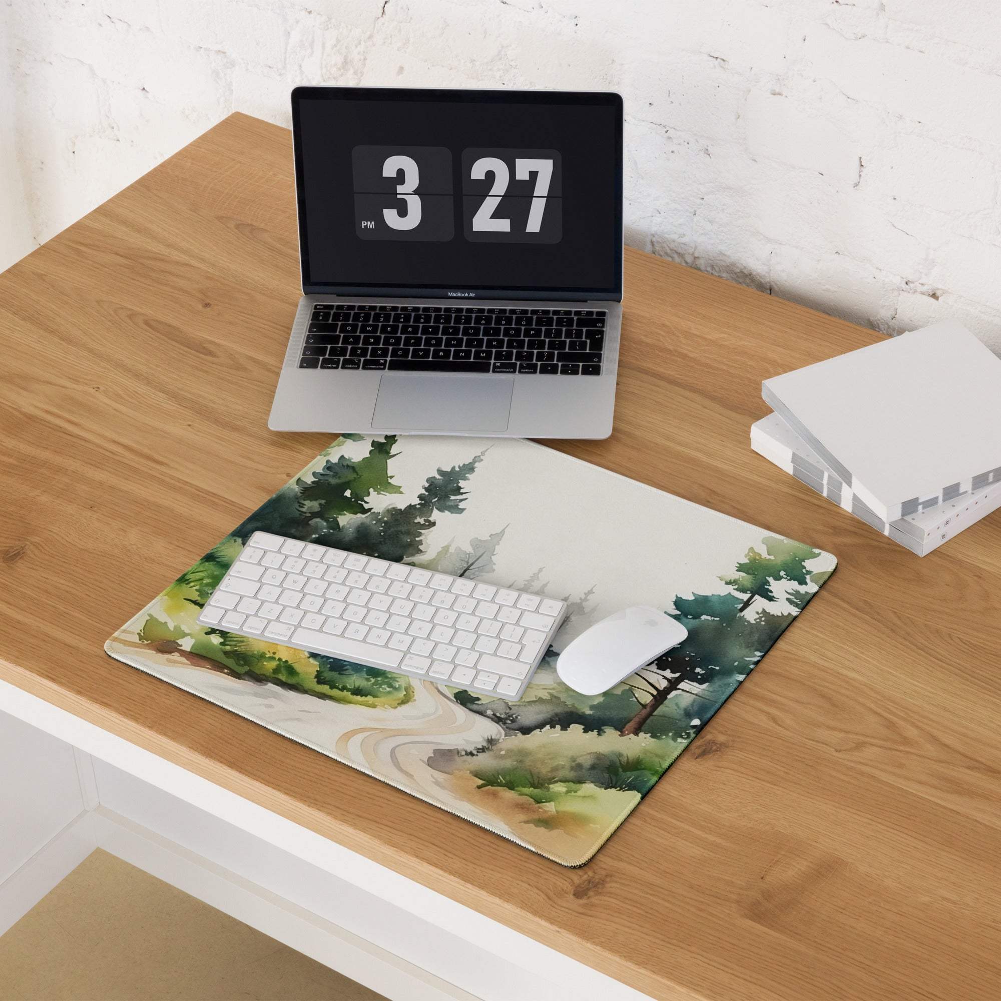 Large forest watercolor gaming mouse pad with non-slip backing on wooden desk