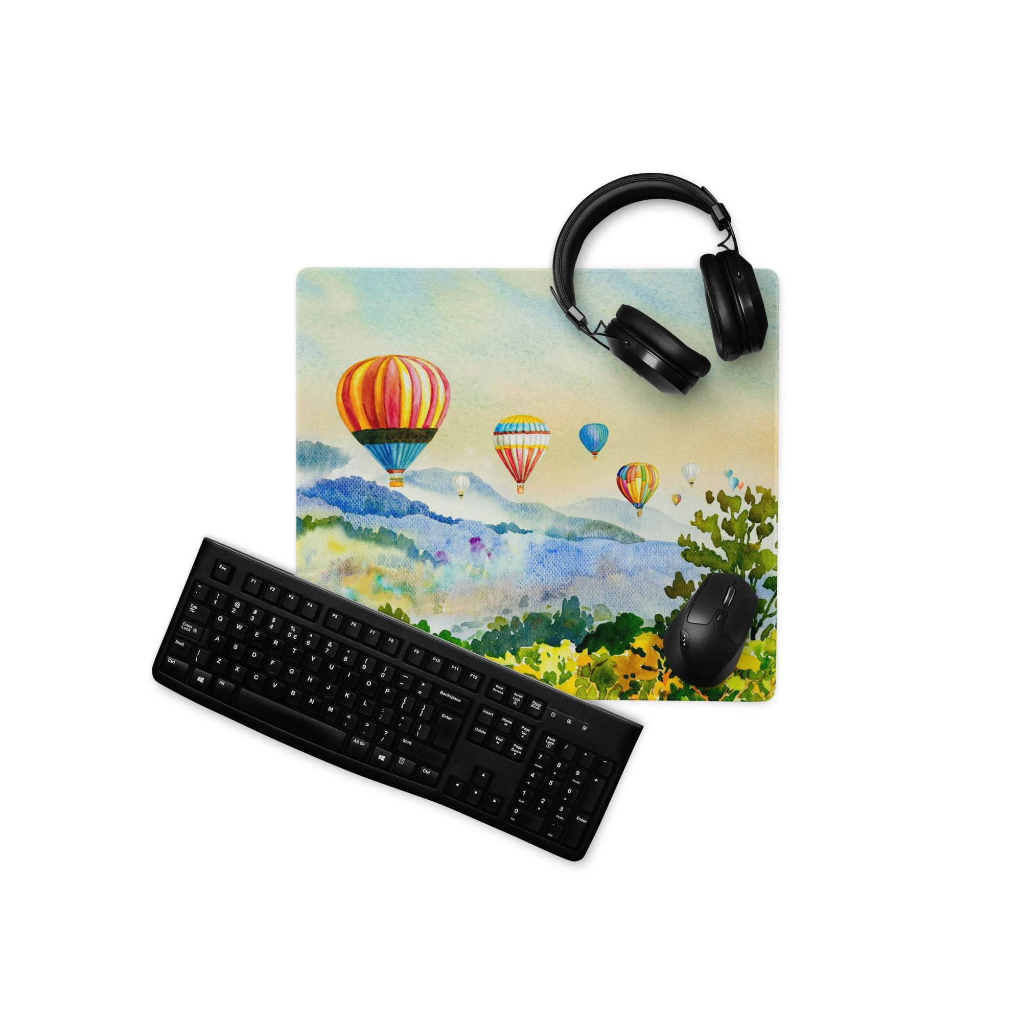 Large watercolor hot air balloon gaming mouse pad with edge stitching, headphones on top