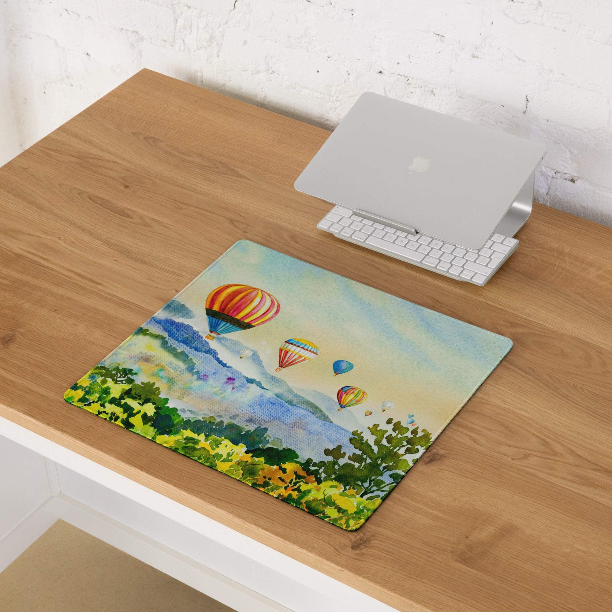 Vibrant watercolor hot air balloons over hills mousepad with stitching, non-slip backing