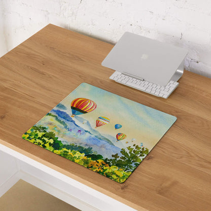 Vibrant watercolor hot air balloons over hills mousepad with stitching, non-slip backing
