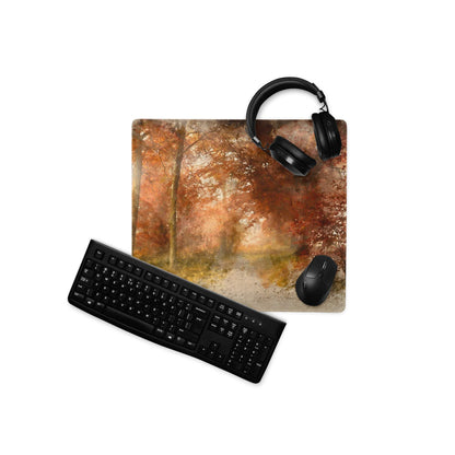 Black matte over-ear headphones on watercolor autumn forest gaming mouse pad