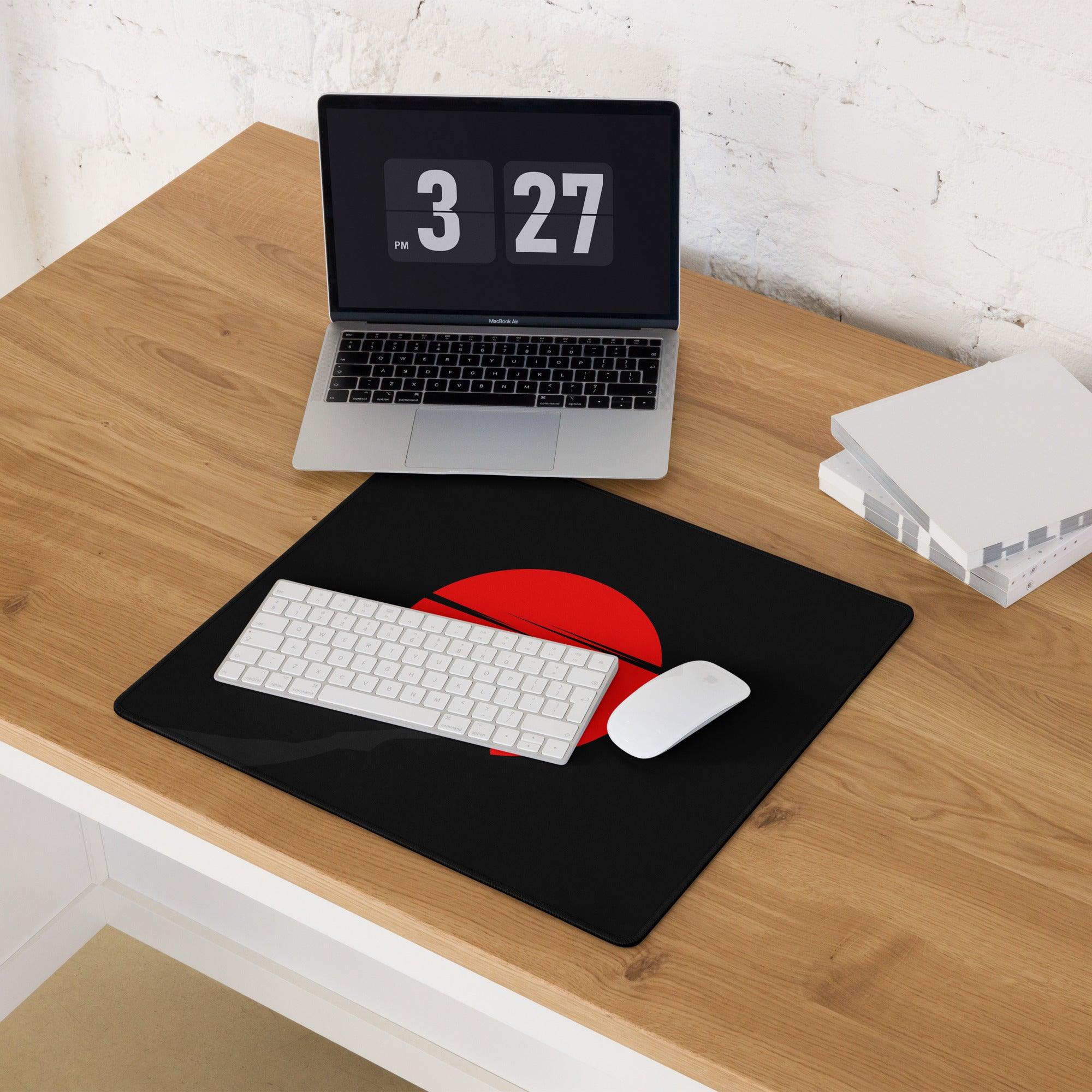 Large black gaming mouse pad with bold red sun slit design, non-slip base
