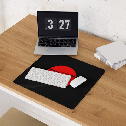 Large black gaming mouse pad with bold red sun slit design, non-slip base