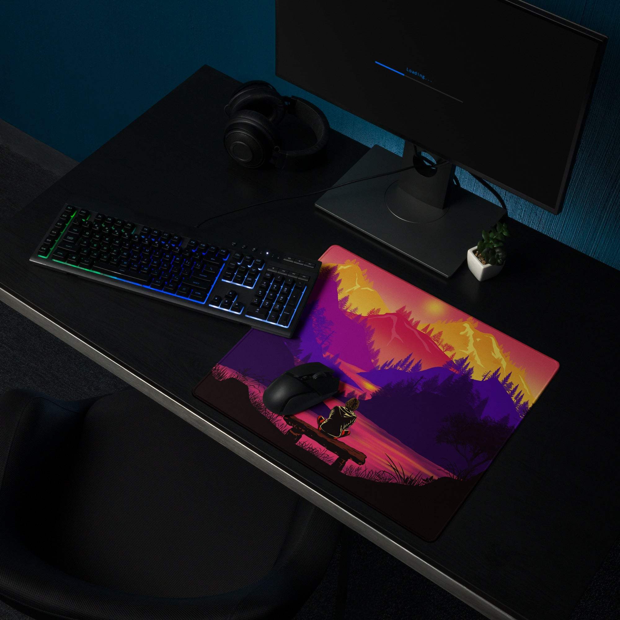 Stylized sunset mountain landscape gaming mouse pad with silhouetted person on bench in purple orange pink gradient