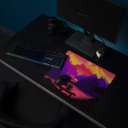 Stylized sunset mountain landscape gaming mouse pad with silhouetted person on bench in purple orange pink gradient