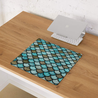 Teal mermaid scale gaming mouse pad with non-slip base on wooden desk