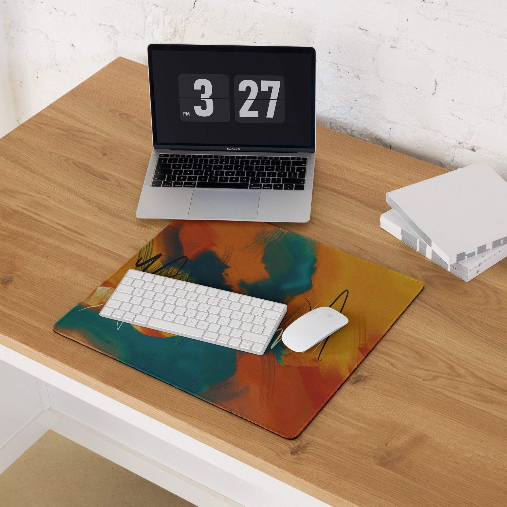 Large abstract art gaming mouse pad in vibrant orange teal yellow with non-slip base stitching