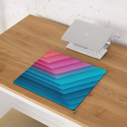Vibrant pink to teal gradient gaming mouse pad with chevron stripes, non-slip base, stitching